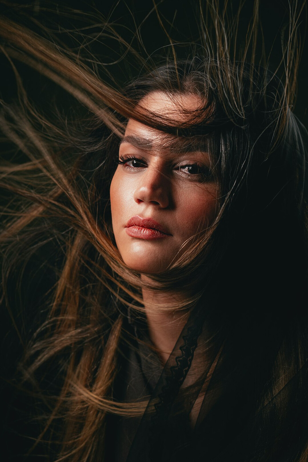 Studio portrait of a woman with long dark hair