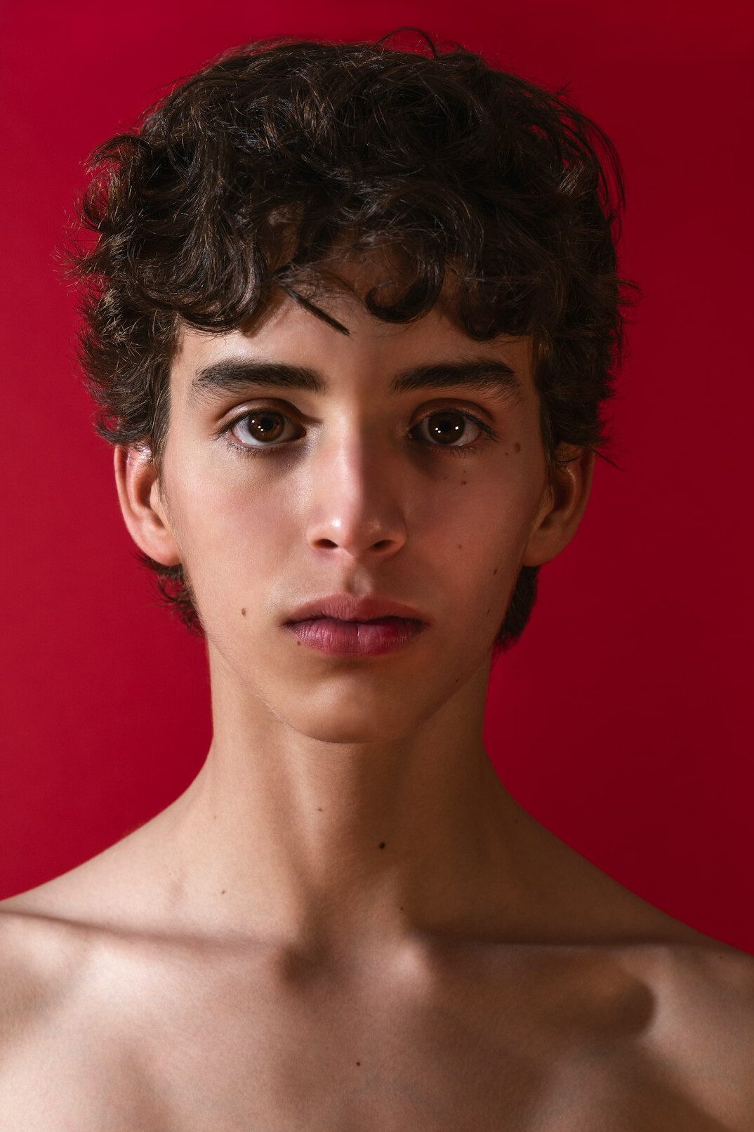 Studio portrait of a young man with short dark hair